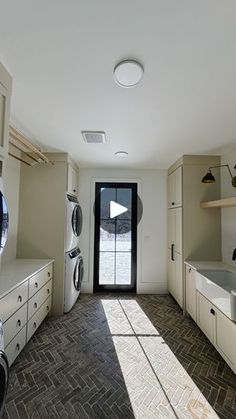 an empty kitchen with washer and dryer in it