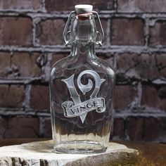 an old fashioned glass bottle with the name vincer on it sitting on top of a piece of wood