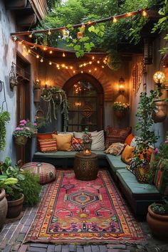 an outdoor patio with potted plants and lights