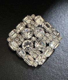 "Stunning vintage pin perfect for the holidays!   It is silver tone set with bright clear crystal stones. It measures 2.25\" x 2.25\".  It is in excellent condition." Vintage Diamond White Brooches For Formal Occasions, Silver Crystal Pins For Wedding, Silver Crystal Wedding Pins, Vintage Silver Brooches With Sparkling Stones, Vintage Diamond White Brooch For Gift, Silver Crystal Brooch Pin, Silver Jeweled Brooches For Formal Occasions, Formal Silver Jeweled Brooches, Formal Crystal Rhinestone Brooches