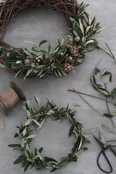 two wreaths and some scissors are laying on the ground