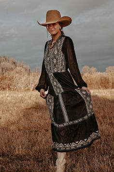 This maxi dress is perfect for a special occasion. Crafted from a woven fabric with elegant embroidery, it has a comfortable elastic waist, sheer long sleeves, and is fully lined for comfort. This timeless piece is sure to make a statement. 100% Polyester. Embroidered Western Dresses, Western Winter Dress Outfit Ideas, Long Sleeve Western Dress, Western Style Dresses For Women, Long Dress And Cowboy Boots, Montana Wedding Guest Outfit, Long Dress With Cowboy Boots, Beth Dutton Yellowstone Outfits, Cowboy Party Outfit