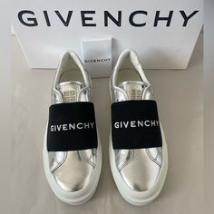 These Givenchy Sneakers Feature A Metallic Leather Upper With An Elastic Logo Strap Across The Vamp. Leather Upper Round Toe Slip-On Style Rubber Sole Made In Portugal Size 36.5 New In Box With Dust Bag And Care Card. 100% Authentic. Retail: 695. Silver Low-top Sneakers With Metallic Logo, Modern Silver Sneakers With Metallic Logo, Modern Silver Sneakers With Rubber Sole, Luxury Silver Sneakers With Rubber Sole, Metallic Silver Leather Sneakers With Round Toe, Silver Low-top Metallic Leather Sneakers, Silver Metallic Leather Low-top Sneakers, Silver Metallic Leather Sneakers With Round Toe, Sporty Silver Sneakers With Branded Heel Counter