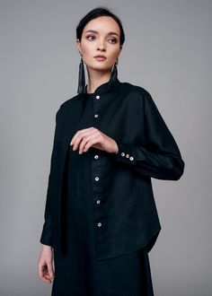 The classic IRA LYSA Kimono Black Shirt is a fan-favorite. The loose style offers versatility and the details, such as the collar, mean business. This is a fresh take on the work(wo)man's shirt in beautiful linen and delicate shell buttons. * Loose cut* Classic stand collar* Shell buttons down the front of the shirt* Dolman sleeves* Yoke on the back one-piece with sleeves* Placket cuff Material: 100% European linen, natural shell buttons Handmade. Always. Corset Boning, Lace Trim Blouse, Reversible Top, Black Spaghetti Strap, Obi Belt, Linen Tank, Corset Belt, Moscato, European Linens