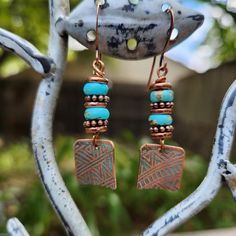 the earrings are made with copper and turquoise beads