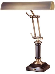 a lamp that is on top of a wooden stand with a white light behind it