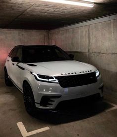 a white range rover parked in a parking garage