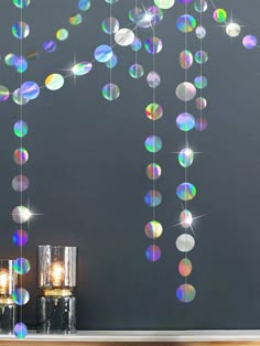 a wall with some lights hanging from it's sides and bubbles coming out of the ceiling