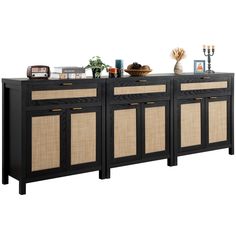 the sideboard is made from black wood and has wicker panels on each side