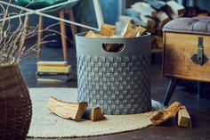 a gray basket sitting on top of a wooden floor