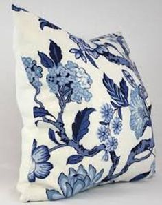 a blue and white pillow with flowers on it