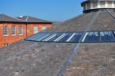 the top of a building with a skylight on it's roof and two buildings in the background