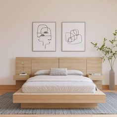 a bedroom with two paintings above the bed