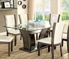 a glass dining table with white chairs in front of a window and beige rug on the floor