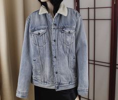 "Levi Jeans jacket Sherpa lined Light blue wash Good condition no damage just light wear 100% Cotton Tag size Large Washed and ready to wear Measurements Underarm to underarm: 22\" Chest up to 44\" Max Waist: Up to 44\" Total length from top of shoulder to hem: 27\" Sleeve length: 26\"  Shoulder seam to shoulder seam: 19\" We offer a fair return policy! Check out our policies for details" Levi Jean Jacket, Jacket Sherpa, Line Light, Jeans Jacket, Trucker Jacket, Levi Strauss & Co, Sherpa Lined, Levi Strauss, Denim Jean