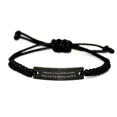 a black bracelet with an engraved message on it