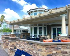 an outdoor patio with stone walls and seating