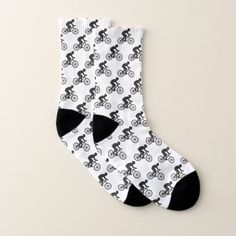 a pair of black and white socks with bicycles on them