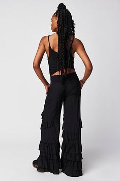 Make a statement for the frill of it in these need-now novelty pants. **Fit:** Mid-rise, billowy tiered design **Features:** Pull-on design, tiered ruffle trimming, raw-edge details, back smocked waistband feature **Why We | Rock And Frill Pants by Free People in Black, Size: S Chic Tiered Bottoms With Ruffle Hem, Chic Tiered Ruffle Hem Bottoms, Chic Wide Leg Ruffled Pants, Chic Summer Wide Leg Pants With Ruffles, Fitted Wide Leg Bottoms With Ruffle Hem, Bohemian Wide-leg Pants With Ruffles, Fitted Tiered Ruffle Bottoms, Black Bottoms With Layered Hem For Summer, Bohemian Bottoms With Ruffle Hem And Tiered Shape