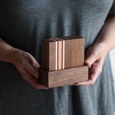 a person holding a wooden block in their hands