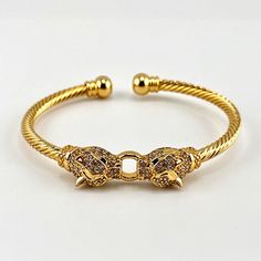 18k Brazilian Gold Filled Jaguar Twisted Bangle Cuff Bracelet Cubic Zirconia Stones Size: 8 In Round (Can Be Adjusted To A Bigger Size) 18k Gold Filled *100% Brand New *100% Guarantee High Quality * 100% Lead And Nickel Free * 100% Hypoallergenic * Will Not Tarnish Or Fade *Smoke Free Pet Free Home - ***Free Jewelry Pouch Included*** Gift For Her Engagement Anniversary Promise Wedding Graduation Vacation Mom Dad Christmas Gift Birthday Girlfriend Boyfriend Husband Wife Tiffany Gift Mens Accessor Gold Cubic Zirconia Cuff Bracelet For Formal Occasions, Luxury Gold Cuff Bracelet With Cubic Zirconia, Gold Cuff Bracelet With Jubilee Style In Cubic Zirconia, Gold Cubic Zirconia Cuff Bracelet With Jubilee Design, Gold Cubic Zirconia Cuff Bracelet With Jubilee Style, Gold Cubic Zirconia Jubilee Cuff Bracelet, Luxury Adjustable Gold Plated Cuff Bracelet, Tiffany Gifts, Brazilian Gold