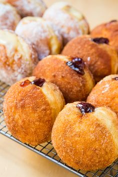 a bunch of doughnuts that are on a wire rack