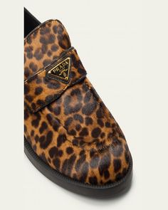 Prada leopardprint dyed calf hair (Italy) loafers with leather trim and triangle logo keeper.    1.00 in / 25 mm flat heel.    Round moc toe.    Notched vamp.    Leather lining.    Slipon style.    Rubber outsole.    Made in Italy. Leopard Print Leather Loafers For Work, Leopard Print Leather Loafers For Fall, Fall Leopard Print Leather Loafers, Leather Leopard Print Loafers With Flat Heel, Leopard Print Leather Loafers With Flat Heel, Leopard Print Flat Heel Loafers For Work, Hair Triangle, Travel Size Perfume, Evening Flats