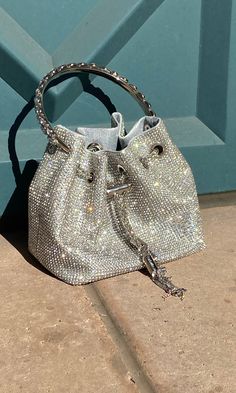 This Crystal Bag is an elegant accessory featuring a full-covered rhinestone design, a detachable chain strap, and a small pouch with a hard crystal metal handle. Perfect for adding a touch of sparkle and sophistication to any ensemble, this bag is a must-have for any fashion-forward wardrobe. Chic Crystal Bags For Events, Chic Embellished Crystal Bag, Chic Embellished Crystal Evening Bag, Chic Evening Crystal Bags, Chic Crystal Evening Bag For Events, Glamorous Silver Shoulder Bag With Chain Strap, Chic Evening Bag With Bling For Night Out, Glamorous Crystal Evening Bag With Rhinestones, Glamorous Crystal Embellished Bags