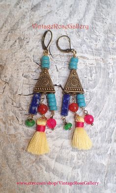 "Colourful Mexican Aztec Earrings, Colourful Bohemian Earrings, Boho Artistic Earrings, Chandelier Earrings A bohemian pair of chandelier earrings inspired by the Mexican and Aztec Jewellery Features : lapis lazuli gemstones, carnelian gemstones , jade , turquoise gemstones , small silk tassels antique bronze findings with mexican style , and antique bronze lever backs . The most interesting , joyful, impressive, artistic and colourful earrings Measures approx. 2 1/2 \" - 7 cm in length. 🌹Selec Bohemian Multicolor Dangle Plug Earrings, Multicolor Bohemian Dangle Plug Earrings, Bohemian Chandelier Earrings For Pierced Ears, Multicolor Brass Drop Earrings, Multicolor Brass Beaded Earrings For Festival, Bohemian Brass Chandelier Earrings As Gift, Bohemian Tassel Earrings With Dangling Beads, Unique Dangle Tassel Earrings For Festivals, Unique Tassel Dangle Earrings For Festivals