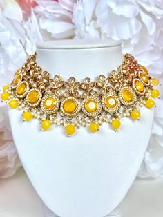 Yellow and Gold Jewelry Set for Indian Wedding  I ADORE this bright yellow Indian jewelry set. The vibes are perfect to pair with your mehndi or sangeet look. This set features: 1 Large choker style necklace with adjustable gold cord 1 Pair of matching earrings 1 Matching tikka  Shop more of our Indian Jewelry sets here: https://www.etsy.com/shop/jazzyandco?section_id=23702907 *Please Note* Processing time will take 2-3 days once your order has been placed. Shipping time varies by location (5 da Elegant Yellow Jhumkas For Festive Season, Elegant Yellow Jhumkas For Wedding, Festive Yellow Elegant Jhumkas, Yellow Round Necklace For Celebration, Elegant Yellow Jhumkas For Gift, Elegant Yellow Jhumkas As Gift, Elegant Yellow Kundan Jewelry, Yellow Round Temple Jewelry Necklace, Festive Yellow Jewelry Sets As A Gift