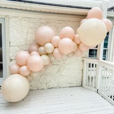 a bunch of balloons that are on the side of a building