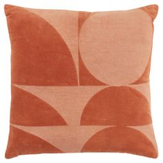 an orange and white pillow with circles on it