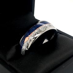 a wedding ring with two tone gold and silver in a black box