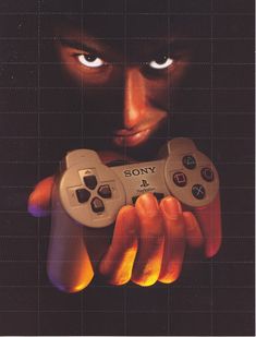 a man holding two video game controllers in his hands with the words sony on it