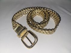 Really cool vintage gold belt.  From 70s/80s!  Excellent condition.  Faux gold leather woven into chains.  One size fits most.   39 inches long, 1 1/4 inches wide.  I'll happily combine shipping, message me! Vintage Adjustable Gold Belt, Gold Adjustable Chain Belt For Formal Occasions, Adjustable Gold Belt Buckle, Adjustable Gold Chain Link Belt, 80s Fashion Style, 70s 80s Fashion, Gold Belt, Gold Belts, Leather Weaving