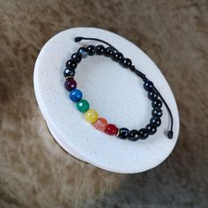 LGBTQ Rainbow Gemstone Bracelet - Discreet Pride Bracelet, Adjustable Cord Jewelry, Handmade Gift for Women's & Men's LGBTQ Rainbow Bracelet, a stunning Pride Gemstone Bracelet featuring the iconic Gay Flag colors. This Adjustable String Bracelet, handmade with care, makes for a perfect Pride Month Gift or a thoughtful Christmas Gift for Her and Him. Details: - Minimalist, elegant, and casual design. - Crafted with 6mm rainbow color agate and black agate stones, hematite beads. - Adjustable fit Adjustable Rainbow Jewelry With 8mm Beads, Adjustable Spiritual Gemstone Beads Wristband, Rainbow Hand-strung Round Jewelry, Rainbow Bracelets With Round Natural Stones, Adjustable Rainbow Bracelets With 8mm Beads, Adjustable Rainbow Stretch Bracelet Spiritual, Adjustable Rainbow Stretch Bracelet, Spiritual Style, Adjustable Rainbow Spiritual Stretch Bracelet, Adjustable Black Pearl Bracelet