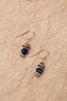 Discover the vibrant and stunning colors of the Blue Moon Collection in these eclectic earrings! Gold Filled (Lead & Nickel Free) Pyrite, Abalone, Lapis Lazuli, Labradorite 1" with gold filled ear wires We hand select our natural materials, thus there may be slight variations in color and/or size that will not detract from the overall aesthetic. Our unique handcrafted designer jewelry for women is made in America, each design created individually in our personal design studio in Floyd, VA USA Blue Earrings With Natural Stones, Elegant Lapis Lazuli Dangle Jewelry, Blue Spiritual Earrings With Round Beads, Eclectic Earrings, Gold Bohemian Lapis Lazuli Jewelry, Blue Round Beads Spiritual Earrings, Spiritual Blue Earrings With Natural Stones, Bohemian Lapis Lazuli Earrings As Gift, Blue Brass Earrings With Natural Stones