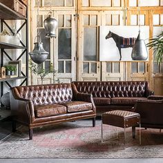 a living room filled with furniture and lots of wood paneled wall art on the walls