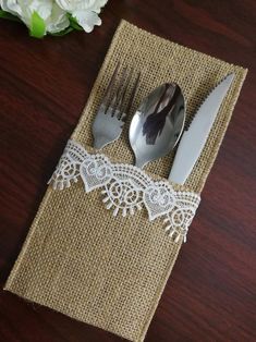 two forks and spoons sitting on top of a place mat