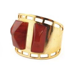 Description: Vintage cuff with a three piece bakelite on gold toned metal.Colour: Cherry Amber tonedDimensions: Height: 4.5cmDiametre: 4.5cm Materials: Bakelite, metal. Era: 1950'sCondition: Excellent Formal Yellow Gold Brass Cuff Bracelet, Vintage Cuff Bangle With Polished Finish, Formal Polished Brass Cuff Bracelet, Formal Brass Cuff Jewelry, Vintage Polished Cuff Jewelry, Gold Modernist Cuff Bracelet For Formal Occasions, Vintage Brass Cuff Bracelet For Formal Occasions, Antique Brass Cuff Bracelet For Formal Occasions, Elegant Bakelite Bangle As Gift