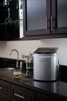 a kitchen counter top with a small ice bucket on it