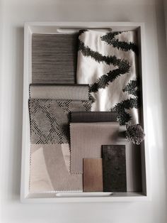 an assortment of color swatches in a white box with pine branches on the side