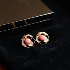 Experience the allure of royalty with our Pink Queen Conch Pearl Rose Earrings. Adorned with exquisite pink pearls sourced from the majestic Queen Conch shell, these earrings embody elegance and sophistication. The seamless blend of the lustrous pink pearls with delicate rose-shaped white Mother of Pearl petals creates a stunning visual harmony. Crafted with 925 sterling silver, these earrings are a testament to impeccable craftsmanship and enduring beauty. Embrace the regal charm of our Pink Qu Elegant Rose-colored Floral Jewelry, Elegant Pink Pearl Jewelry, Luxury Pink Earrings For Wedding, Luxury Pink Jewelry With Matching Earrings, Luxury Rose Gold Pearl Jewelry, Rose Flower-shaped Elegant Earrings, Elegant Pink Gold Flower Jewelry, Elegant Rose Flower-shaped Earrings, Elegant Pink Flower-shaped Jewelry