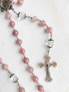 A Beautiful Rose Pink Rosary “I take refuge, then, in prayer, and turn to Mary, and our Lord always triumphs.” - St. Therese of Lisieux Elevate your Rosary Beads praying experience with this stunning rose pink rosary. The Our Lady’s Garden gemstone rosary is made with aventurine and sparkling Czech fire-polished glass beads, making it an heirloom-quality piece that will be cherished for life! Made with pink-purple 8mm aventurine gemstones and Czech fire-polished glass beads Solid cast bronze cen Pink Beaded Spiritual Rosary, Pink Healing Rosary With 8mm Beads, Pink Rosary, Bronze Centerpiece, Beads Making, St Therese Of Lisieux, Thérèse Of Lisieux, St Therese, Rosary Catholic