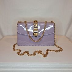 Womens lilac purple patent evening clutch bag with gold buckle and chain embellishment and front magnet closing clasp Can be used with or without long shoulder chain (included) - multiway chain can be pulled through for use as a short chain size approx- H 12cm x W 20cm Free Royal Mail delivery is an estimated 3-5 days but this can occasionally be slightly longer which solely on the Royal Mail side. We do offer guaranteed next day delivery but please contact us prior to ordering as this would incur a small upgraded shipping charge We also offer WORLDWIDE shipping - please contact us for more info 💕🌍 Rose Gold Gifts, Diamond Bows, Blue Sparkles, Shoulder Chain, Cute Purses, Lilac Purple, Evening Clutch Bag, Evening Clutch, Champagne Gold