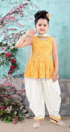 ABOUT THIS ITEM This girl's kurta Patiala set with dupatta is suitable for kids 4-14yrs age. Fabric Details: This is exclusive Bollywood-style party wear featuring excellent craftsmanship, beautiful embroidery, traditional prints, and vibrant colors. The Kurta Patiala set is made with lightweight georgette material that is skin-friendly, breathable, and comfortable to wear for kids. Age Group: 4 - 14 years. For best fitting, please take measurements for your child and refer to the size chart in the last picture before purchase. Wash care Instructions: Do not bleach, Iron at low heat, and Dry Clean ( preferred for first wash). Occasion: Birthday gift, Festive wear, Kids Diwali wear, Party and Casual wear, Wedding, and all special occasions. Package Includes: 1 Kurta +1 Patiala salwar + 1 du Kids Dress Wear Casual, Diwali Wear, Kids Indian Wear, Embroidery Traditional, Sleeveless Kurta, Unique Girls, Georgette Material, Traditional Prints, Kids Ethnic Wear