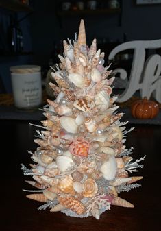 a christmas tree made out of seashells on a table