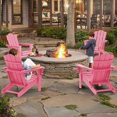 two children sitting in pink chairs around a fire pit