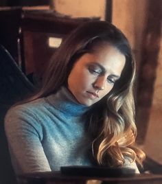 a woman sitting in front of a laptop computer