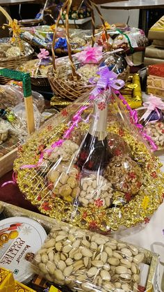 a table topped with lots of food and baskets filled with nuts, crackers and candy